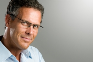 Handsome mature man looking at camera with a pair of modern glasses